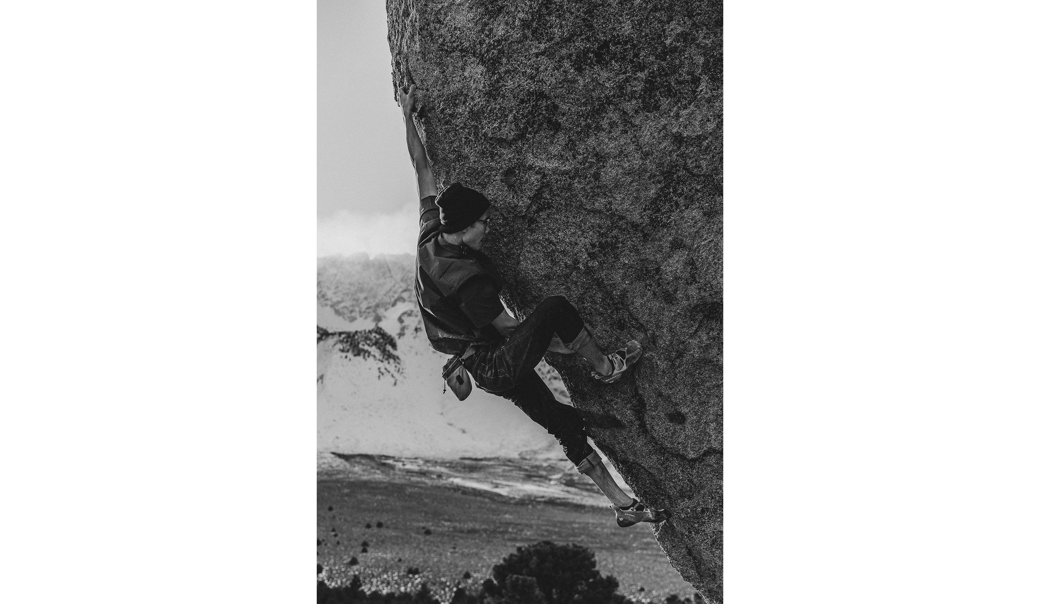 Timmy Kang climbing on a highball boulder in Bishop.