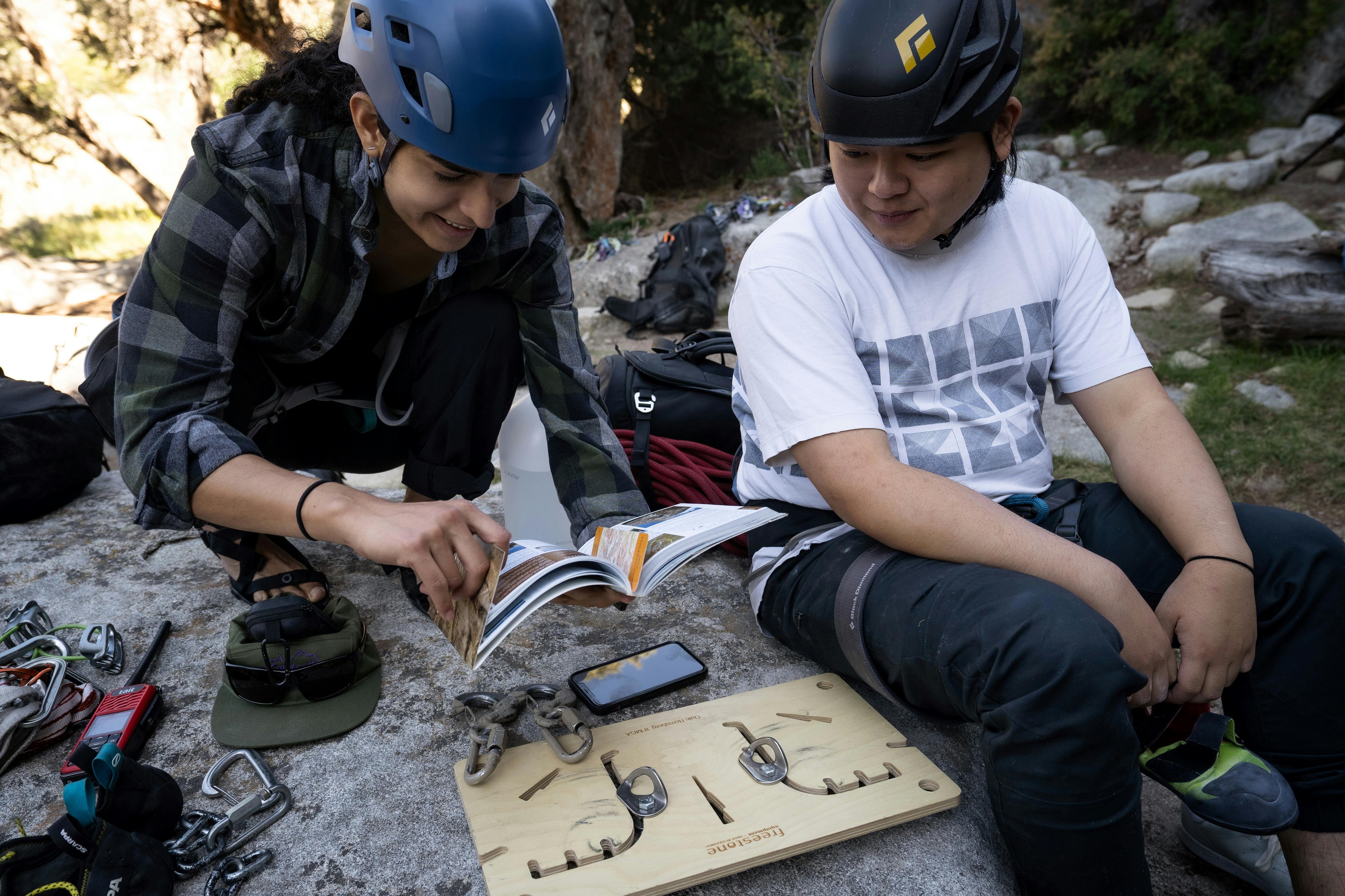 Two climbers practice anchor skills. 