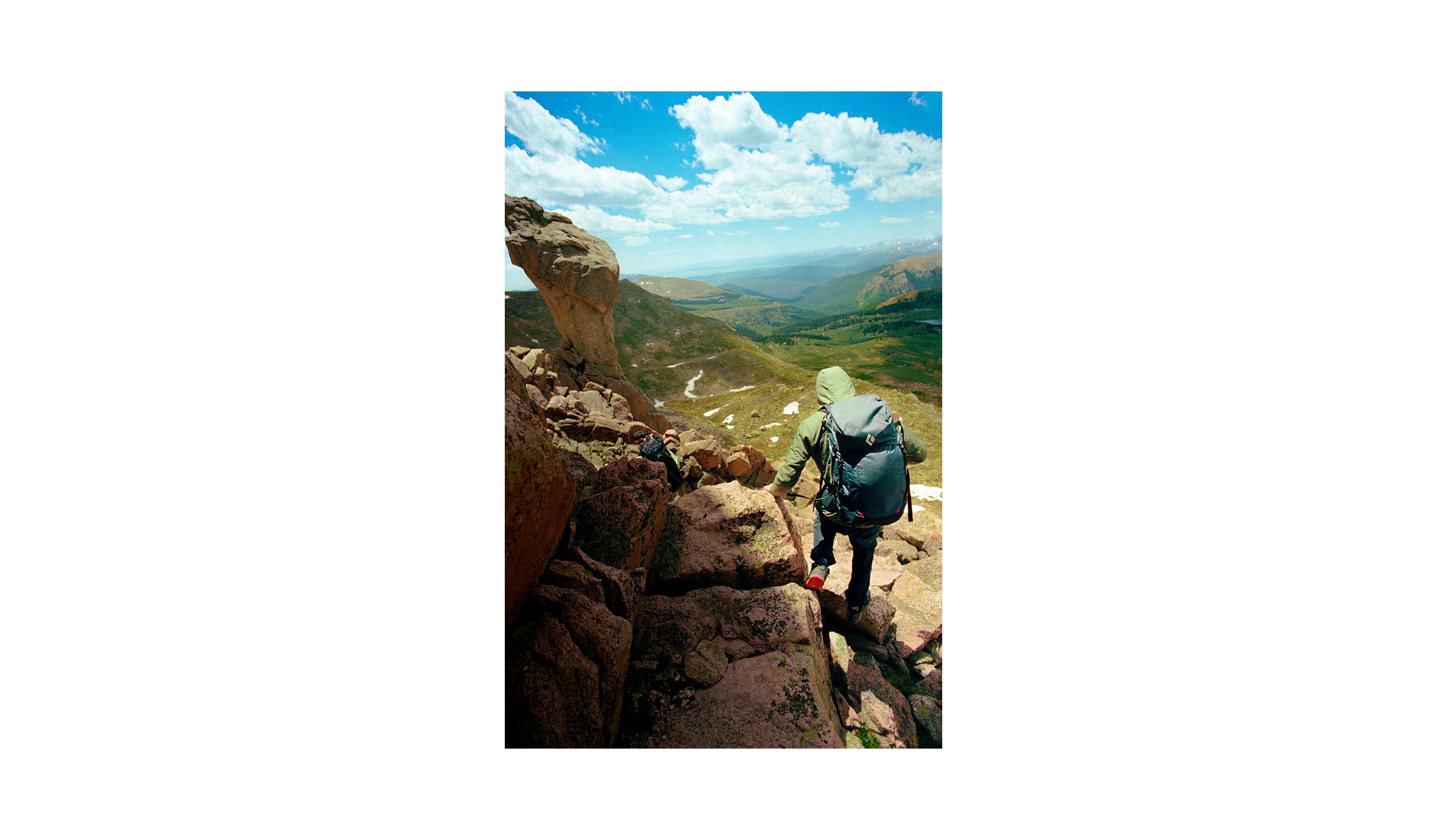 A climber walks along the ridge to the Doubloons Spire