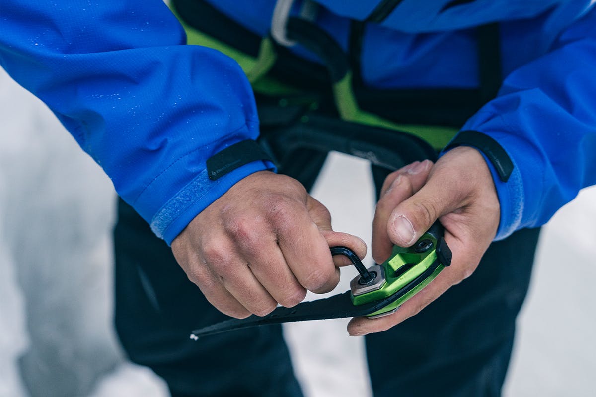 A climber adjusts their Hydra Ice tools in the field. 