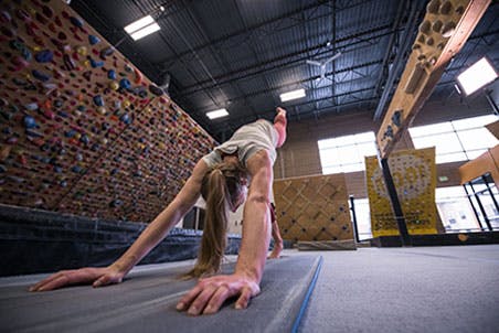 Image of Claire Buhrfeind performing core exercises in a gym.