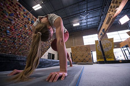 Image of Claire Buhrfeind performing core exercises in a gym.